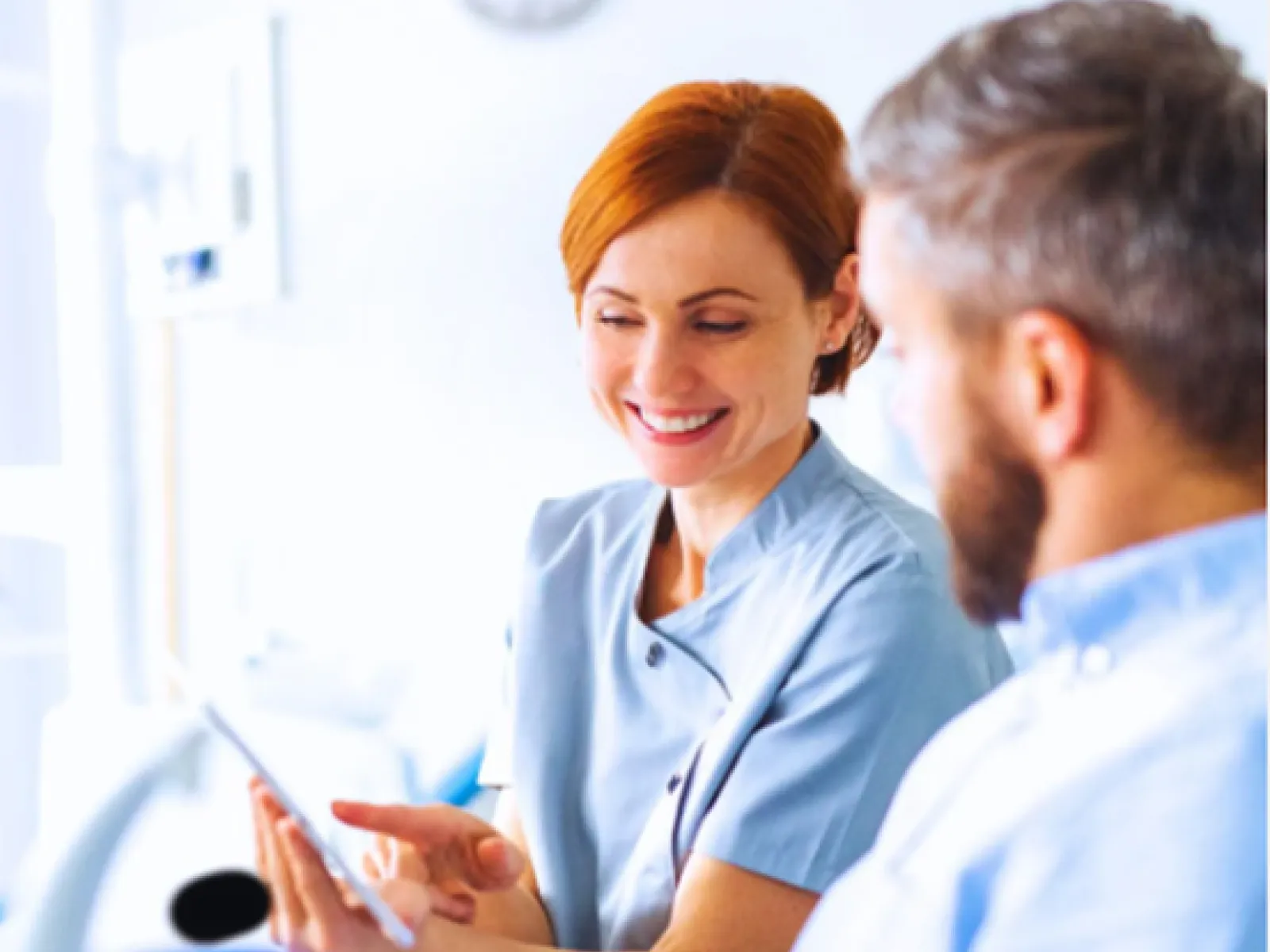 a doctor showing a patient something on the tablet